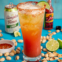 recipe: Michelada with Trader Joe's Simpler Times Lager surrounded by limes and pistachios